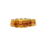 An amber expanding bracelet, with twelve faceted rectangular beads on an elastic string,