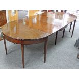 A George III mahogany D-end dining table with central two-flap section on square tapering legs,