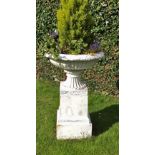 A pair of cast iron garden vases, the flanged tops with egg and dart border and of reeded form,