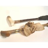 A parasol with mother-of-pearl and gilt metal mounted handle and another with two wavy bands of
