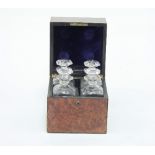 A walnut decanter box containing four cut glass decanters and stoppers, 24cm wide Condition