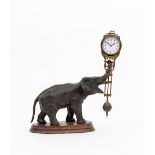 A Junghans mystery or swinger clock of elephant form the patinated spelter elephant with raised