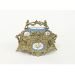 A French gilt metal casket with Paris porcelain mounts painted with cherubs and flowers,