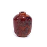 A Chinese amber snuff bottle, carved with a fisherman beneath a pine tree, 6cm high, approximately