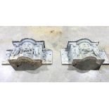 A pair of cast iron wall pockets decorated cherubs and swags,