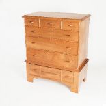 A walnut chest on stand by Bert Uzzell,