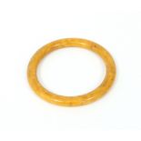 A butterscotch coloured bangle, 8.