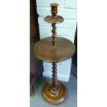 An oak candlestick with spiral column and circular base