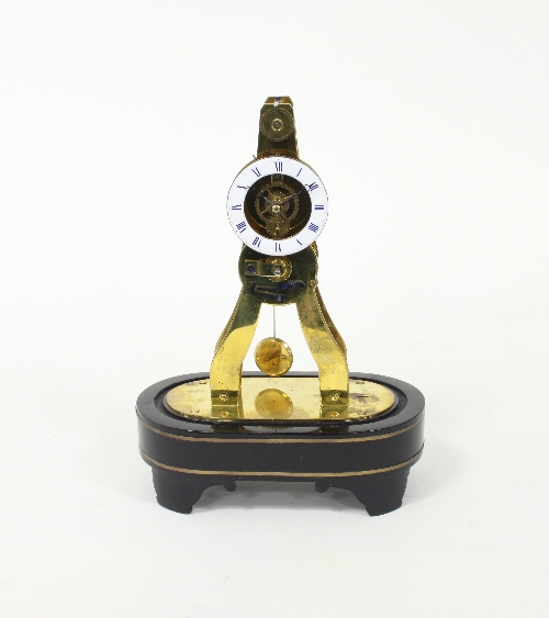 A small gilt brass skeleton clock, the enamel chapter ring with Roman numerals in blue,