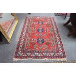 An Afghan rug with red ground central field,