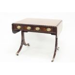 A Regency mahogany sofa table fitted with two drawers each with two brass swing handles, the top and