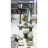 Two garden lights on baluster columns,