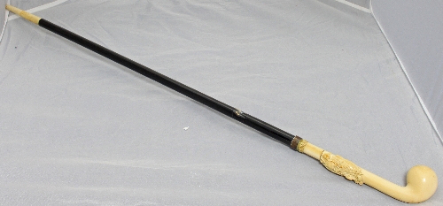 An ivory and ebony walking cane with ivory ball knop and tip,