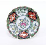 A Japanese Imari dish, painted with flower panels, 18.