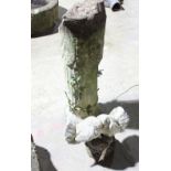 A cylindrical column supporting a figure with two doves,