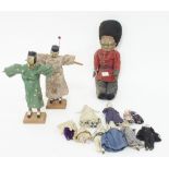 A quantity of dolls house dolls, with bisque heads and hands and material bodies,