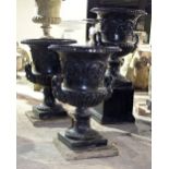 Three cast iron campana shaped two-handled vases with Tudor roses and scrolls in relief,