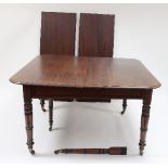 A George IV mahogany extending dining table, fitted four extra leaves on six turned tapered legs,