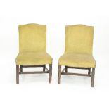 A pair of George III mahogany side chairs with upholstered backs and seats on square moulded legs