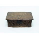 A 17th Century oak bible box, the front with carved lunettes,