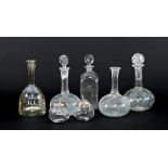 Five glass decanters, various, two lacking stoppers and two apple sauce jars of apple form,