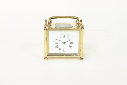 A rectangular gilt brass carriage timepiece, with rectangular dial and eight-day movement,