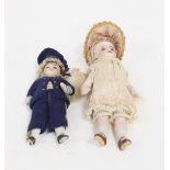 A sailor boy bisque doll with fixed eyes and closed mouth, in a navy buttoned uniform, 10cm,