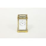 A late 19th Century gilt brass carriage clock, the rectangular enamel dial with Roman numerals and