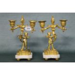 A pair of French 19th century gilt bronze candelabra with cherub supports. Height 23cm, Width 15cm