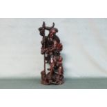 A Chinese carved cherry wood figure depicting the father and son with fish. Height 52cm, Width 21cm