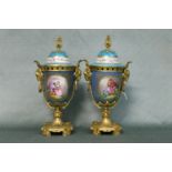 A fine pair of French 19th century Sevres lidded vases with hand painted panels of the courting