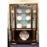 A most outstanding French 19th century flame mahogany empire vitrine having finely detailed ormolu