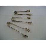 Pair of Silver Sugar Tongs with 2 further plated pairs (3)