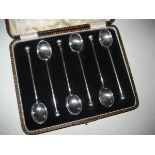 Silver bean handled spoons in presentation case.