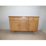 An Ercol light elm sideboard. 121cm wide.