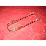 A pair of silver sugar tongs Newcastle