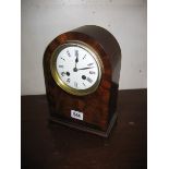 An early 20th Century mantel mahogany clock with eight day movement striking to a bell 26 cm high