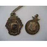 Silver medallion on associated chain together with another silver medallion (2)