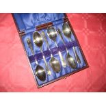 A cased set of golfing silver tea spoons