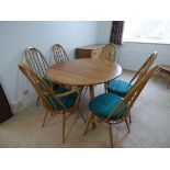 An Ercol light elm drop leaf dining table with a set of (4+2) stick back dining chairs. 113cm wide