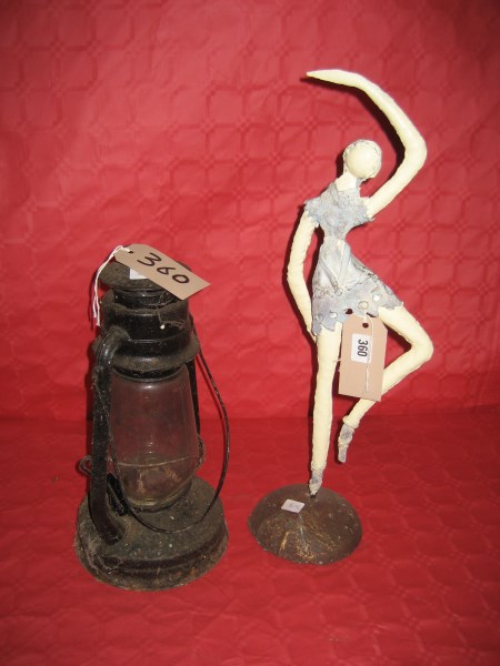 A metal figurine of a belly dancer together with a storm lamp (2)