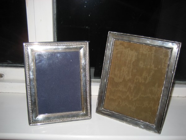 A silver photograph frame together with another (2).