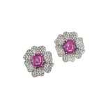 A pair of pink sapphire and diamond earrings
Each of flowerhead design, the oval-cut pink sapphire