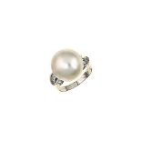 A cultured pearl and diamond ring
The cultured pearl, measuring approximately 15.8mm, between