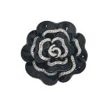 A diamond and onyx brooch / pendant
Modelled as an onyx flowerhead with brilliant-cut diamond line