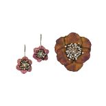 A titanium and diamond brooch and pair of earrings
Of flowerhead design, the brooch composed of pink