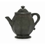 A GERMAN SERPENTINE MARBLE TEAPOT
18TH CENTURY
Of typical form with scrolled handle
5 ½ in. (14 cm.)