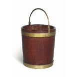 A LATE GEORGE III BRASSBOUND MAHOGANY PEAT BUCKET
LATE 18TH CENTURY
Of typical staved