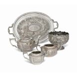 AN INDIAN SILVER THREE-PIECE TEASET AND OVAL TWO-HANDLED TRAY EN SUITE
PROBABLY FIRST QUARTER OF