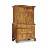 A QUEEN ANNE WALNUT AND BURR WALNUT SECRETAIRE CABINET
EARLY 18TH CENTURY
With cross- and